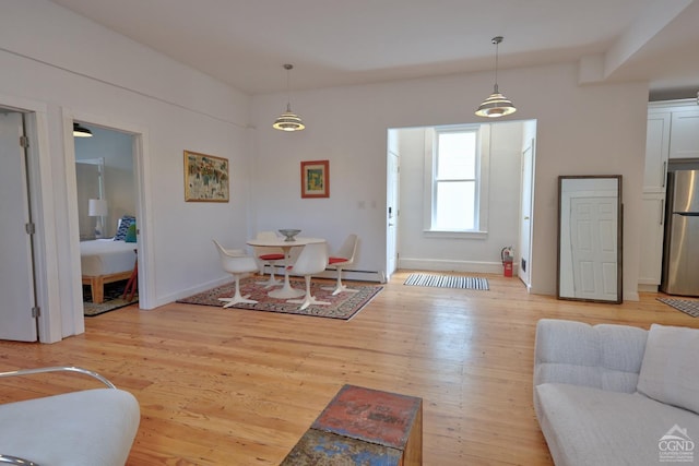 living room with light wood-type flooring and a baseboard radiator