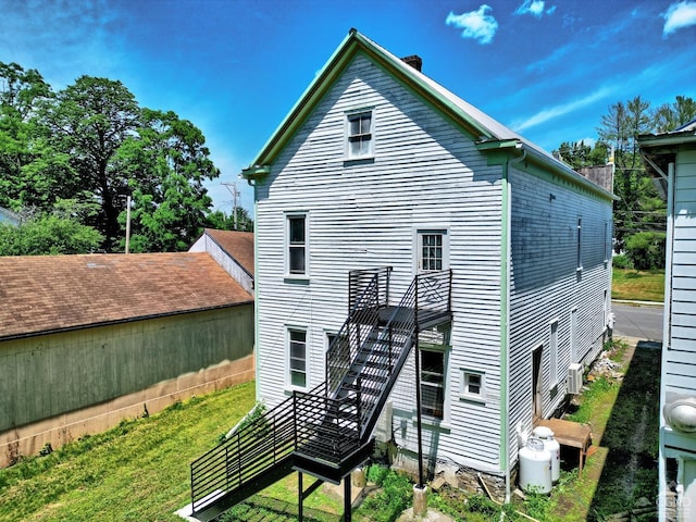 rear view of house with a yard