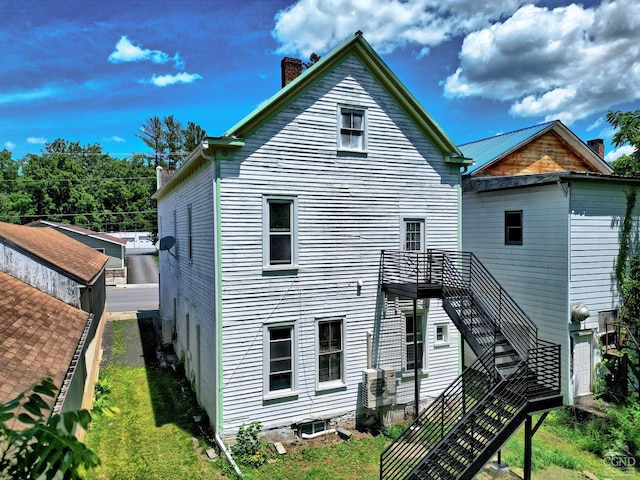 back of property featuring a lawn