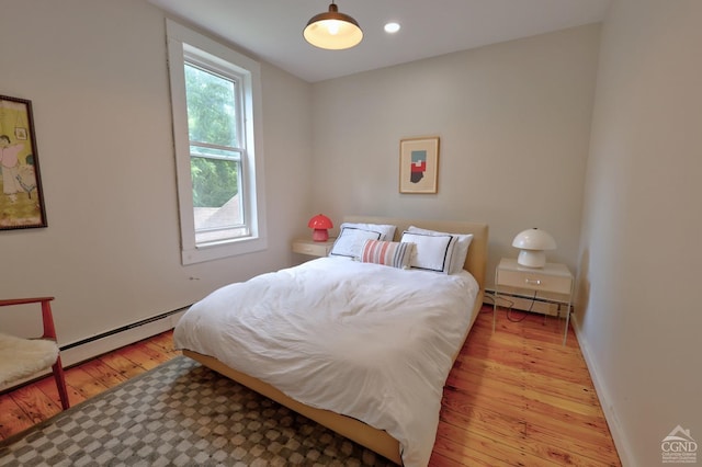 bedroom featuring a baseboard radiator and light wood-type flooring