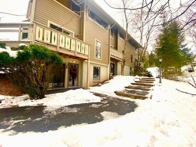 view of snow covered back of property