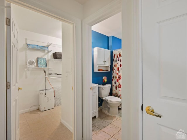 bathroom featuring tile patterned flooring, vanity, and toilet