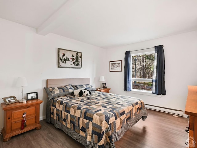 bedroom with beam ceiling, dark hardwood / wood-style flooring, and a baseboard heating unit