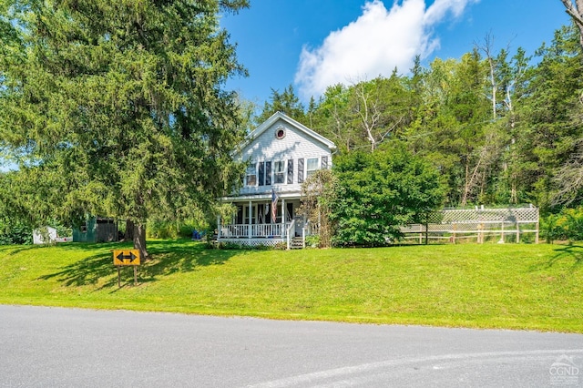 view of front facade featuring a front lawn and covered porch