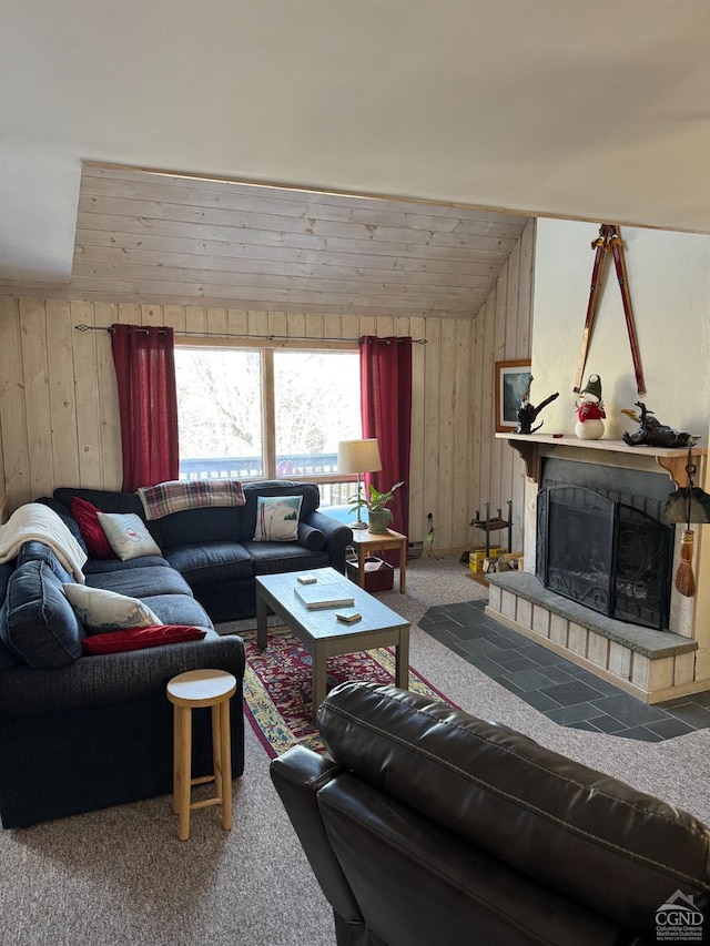 living room with carpet floors, a fireplace with raised hearth, vaulted ceiling, wooden walls, and wooden ceiling