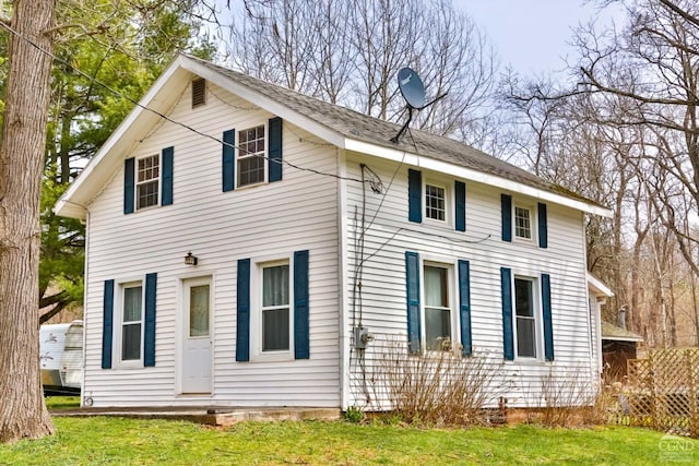 rear view of property with a lawn