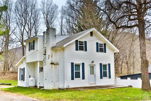 rear view of property with a yard