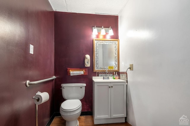 bathroom with hardwood / wood-style floors, vanity, a textured ceiling, and toilet