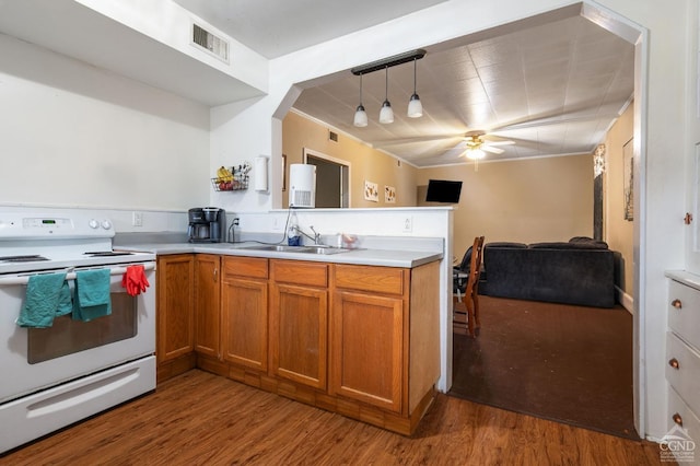 kitchen featuring ceiling fan, sink, hanging light fixtures, white range with electric stovetop, and wood-type flooring