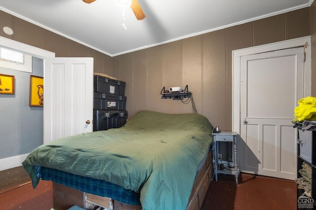 bedroom featuring dark hardwood / wood-style floors, ceiling fan, and ornamental molding