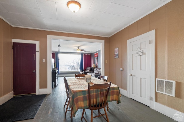 dining area with ceiling fan, crown molding, and dark wood-type flooring