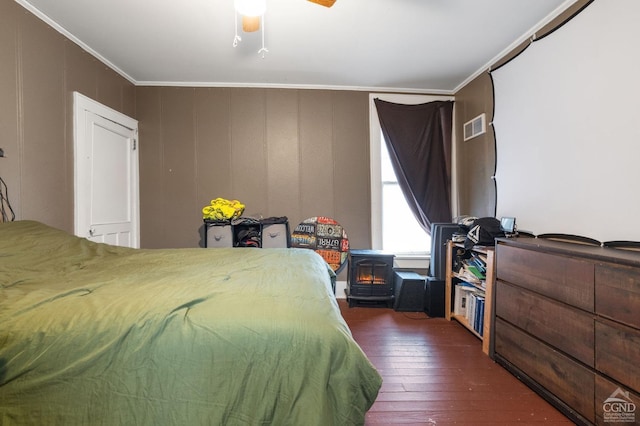 bedroom featuring ornamental molding, ceiling fan, and dark wood-type flooring