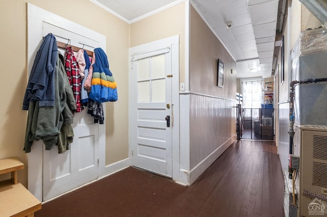 interior space featuring crown molding and dark wood-type flooring