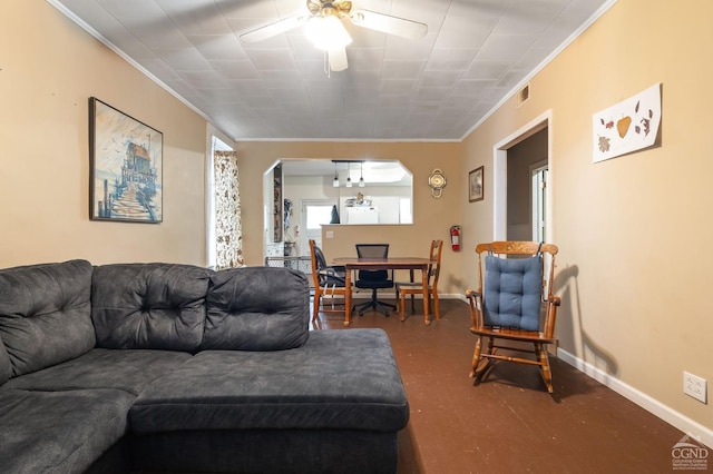 living room featuring ceiling fan and crown molding