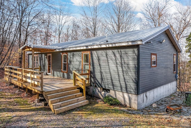 back of property with a wooden deck