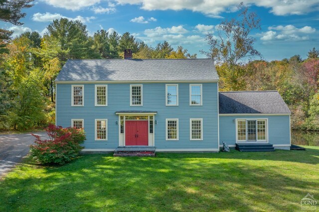 colonial inspired home with a front yard