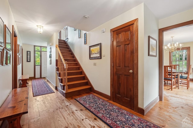 foyer entrance featuring light hardwood / wood-style flooring and a chandelier