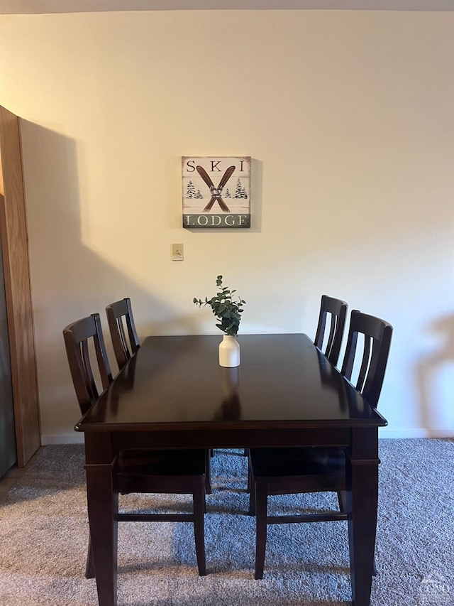 dining space featuring carpet