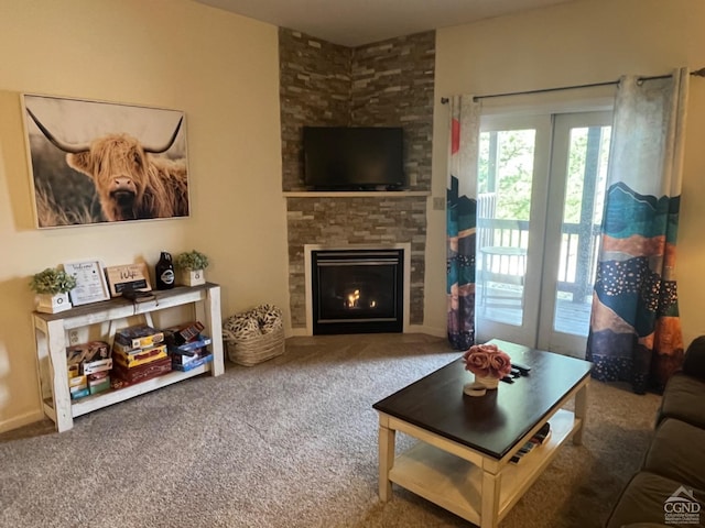 carpeted living room featuring a stone fireplace