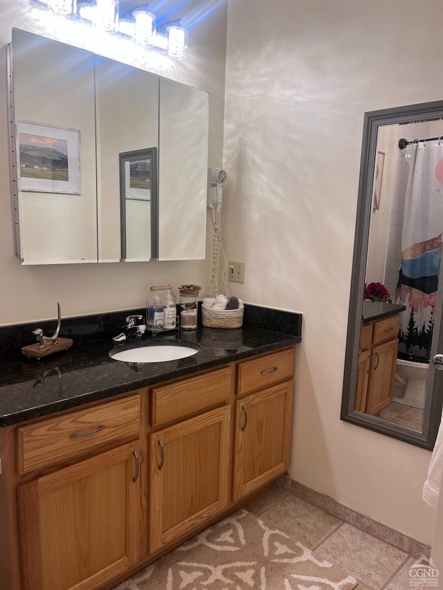 bathroom with tile patterned floors, vanity, and a shower with shower curtain