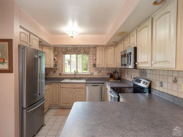 kitchen featuring decorative backsplash, appliances with stainless steel finishes, light brown cabinets, and sink