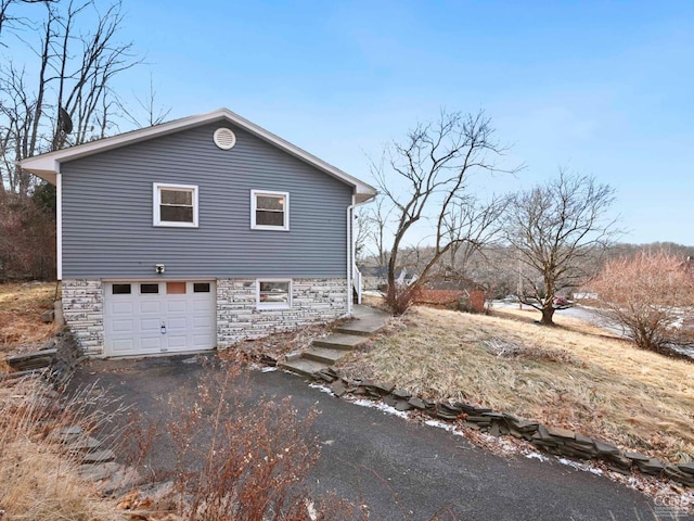 view of side of home featuring a garage