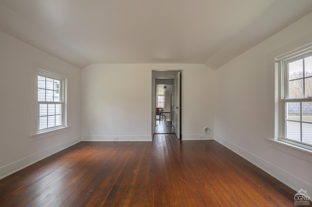 unfurnished room with dark wood finished floors and a healthy amount of sunlight