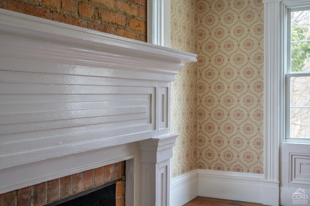 details with wallpapered walls and a fireplace