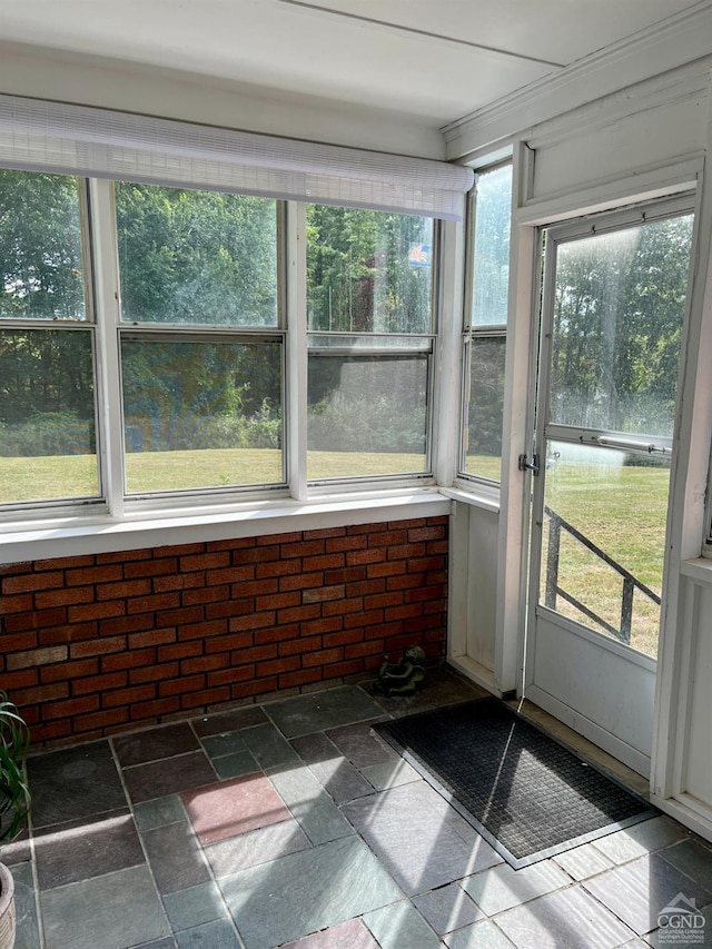 unfurnished sunroom with plenty of natural light