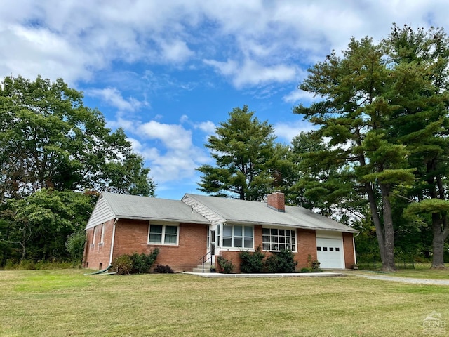 single story home with a chimney, a garage, a front lawn, and brick siding