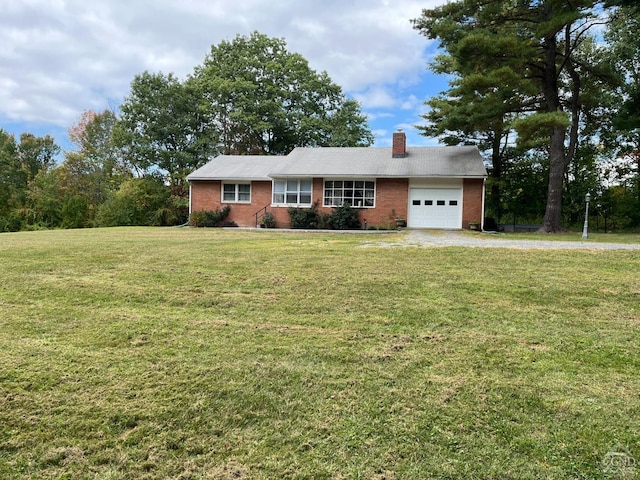 ranch-style home with an attached garage, a chimney, brick siding, a front lawn, and driveway