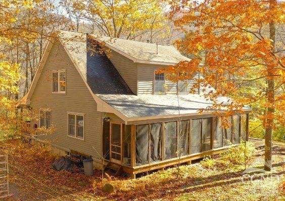 view of side of property with a sunroom