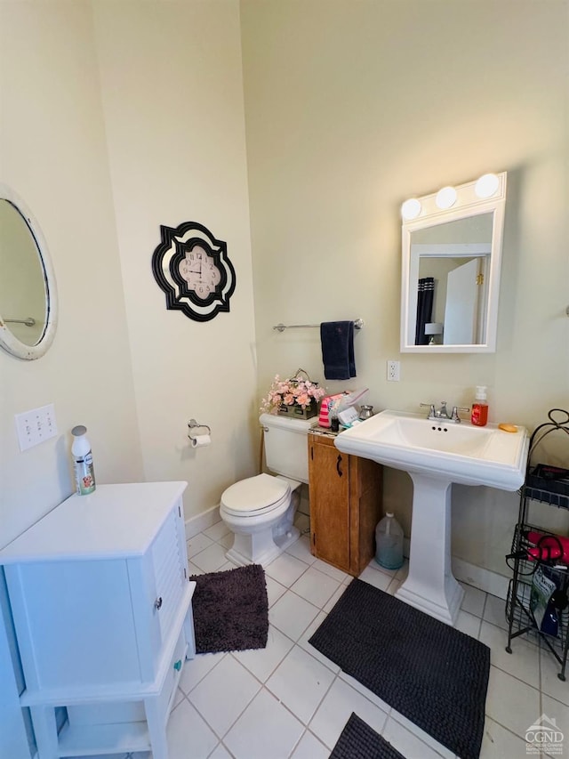 bathroom featuring tile patterned floors, toilet, and sink