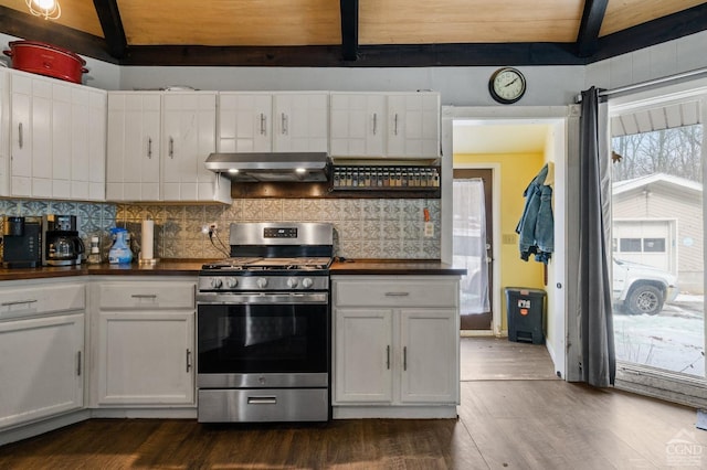 kitchen featuring stainless steel range with gas cooktop, white cabinetry, beam ceiling, extractor fan, and tasteful backsplash