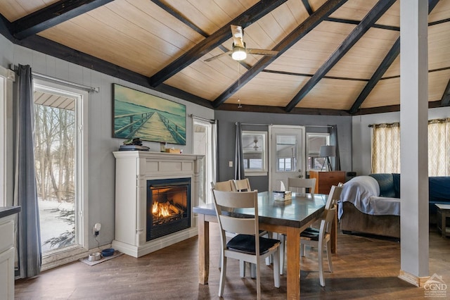 dining space with ceiling fan, vaulted ceiling with beams, dark hardwood / wood-style floors, and wooden ceiling