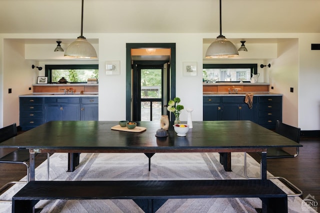 dining room featuring wood-type flooring and sink