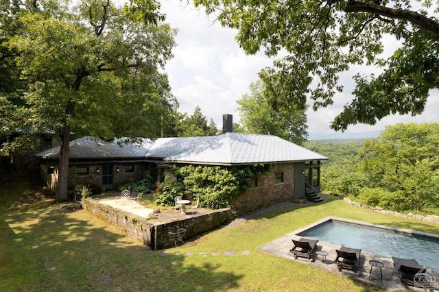 back of house with a yard and a patio area