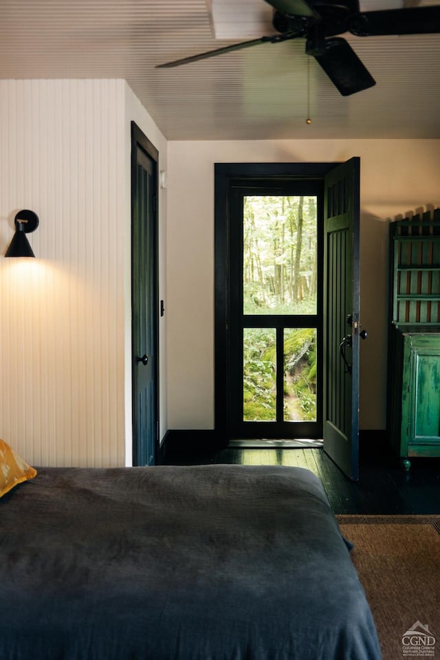 bedroom with ceiling fan and dark wood-type flooring