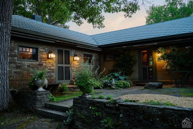 view of back house at dusk