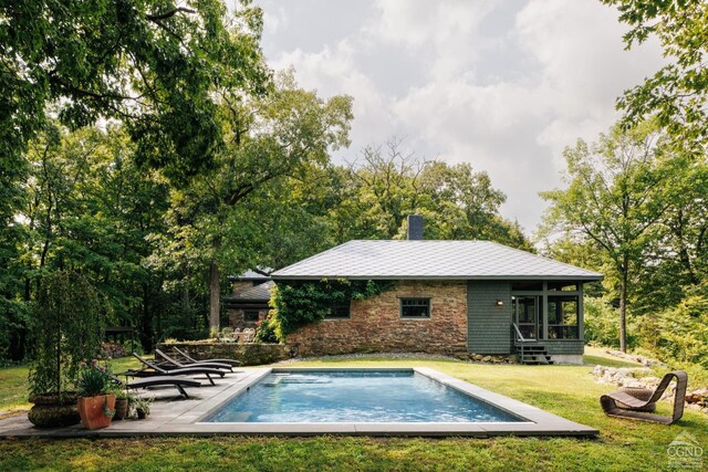 view of pool featuring a lawn and a patio area
