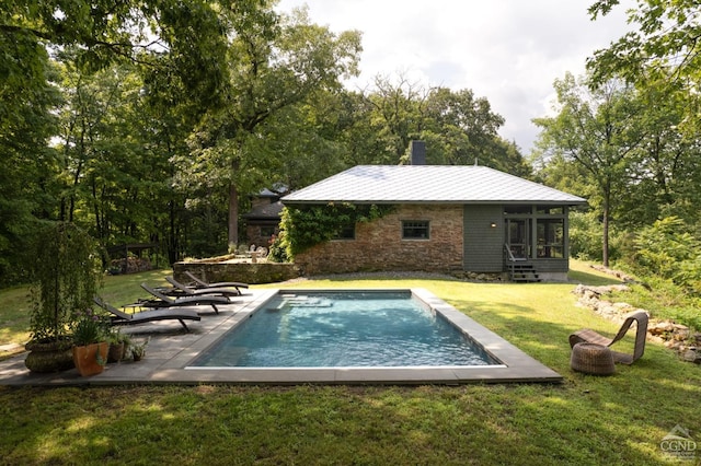 view of pool with a sunroom, a yard, and a patio