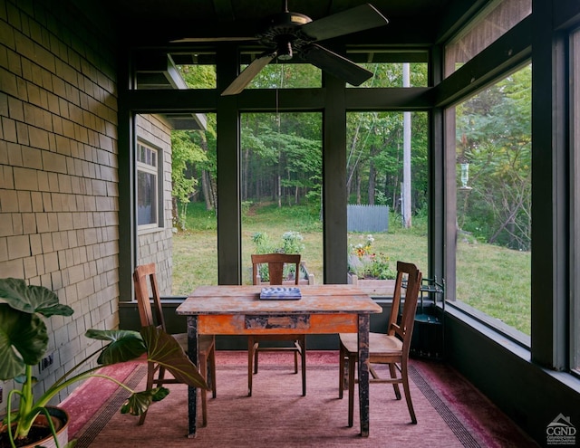 sunroom / solarium featuring a wealth of natural light and ceiling fan