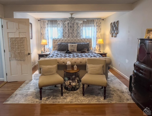 bedroom with wood-type flooring, multiple windows, and ceiling fan