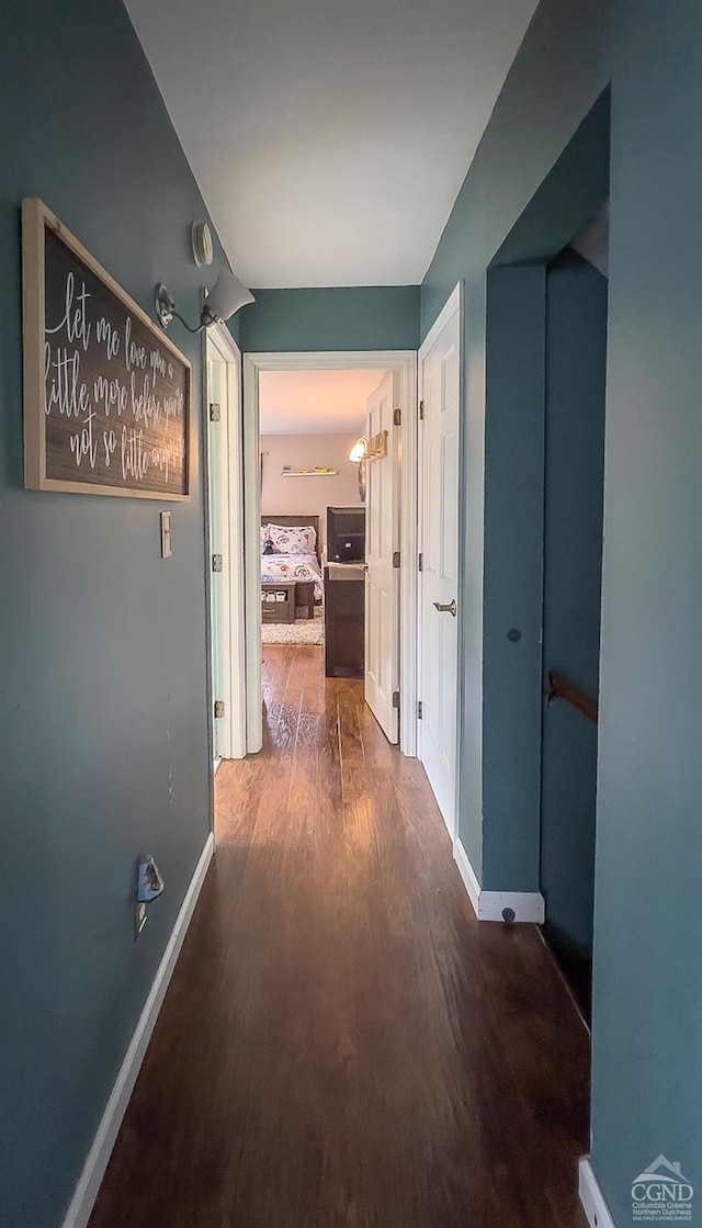 hallway with dark wood-type flooring