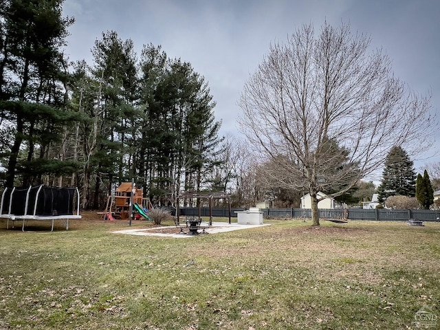 view of yard featuring a playground, a patio, and a trampoline