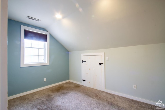 bonus room with carpet flooring and lofted ceiling