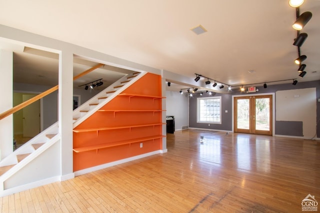 interior space with french doors and wood-type flooring