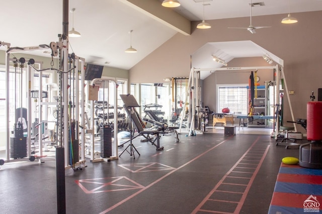 exercise room with ceiling fan and high vaulted ceiling