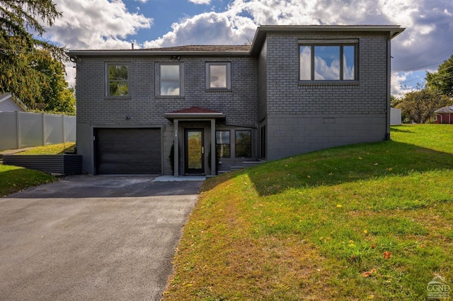 view of front of property with a garage and a front yard