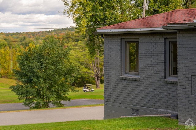 view of side of home featuring a lawn